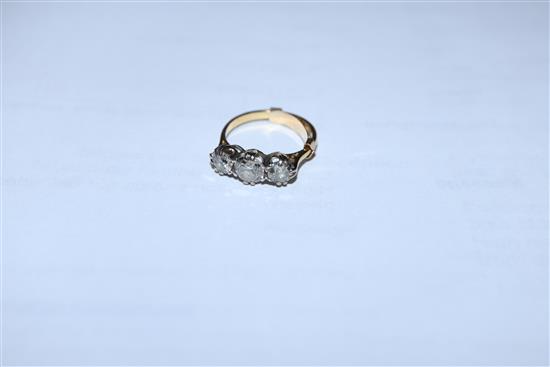 A yellow metal and three stone diamond ring, size H.